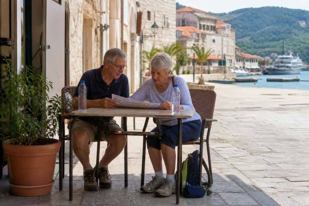 Seniors planning the best Mediterranean cruise itinerary with a port map